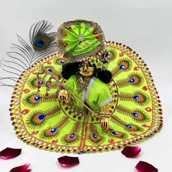 Handcrafted Laddu Gopal dress with peacock feather embroidery, bright green fabric, and decorative embellishments.