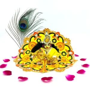 Beautiful Laddu Gopal idol in handmade yellow floral silk dress with peacock feather and rose petals for festive worship.