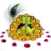 Laddu Gopal idol adorned in a yellow-green handmade silk dress with floral embroidery and stone embellishments, surrounded by rose petals.