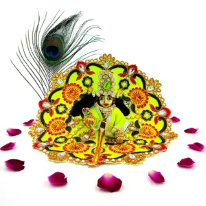 Laddu Gopal idol adorned in a yellow-green handmade silk dress with floral embroidery and stone embellishments, surrounded by rose petals.