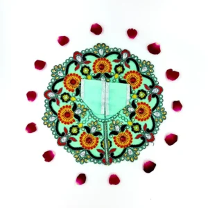 Flat lay view of handmade mint green floral silk Laddu Gopal dress with intricate embroidery, surrounded by rose petals.